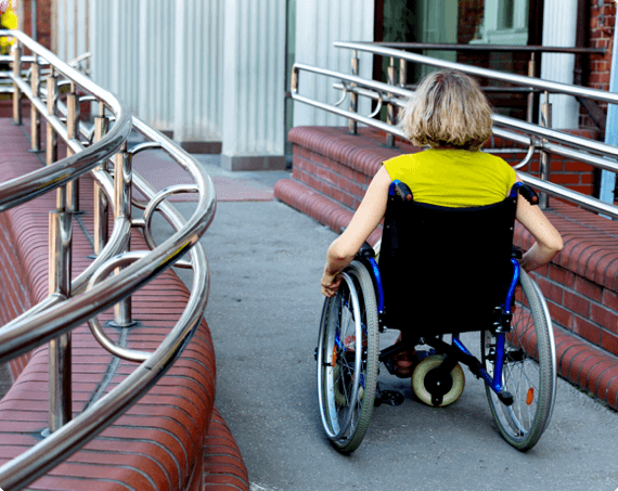 AODA img 1 (1) A worker in a wheelchair moves down a path