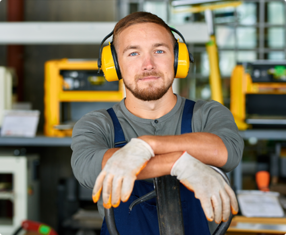 Environmental Sessions img 1 An employee wears hearing protection equipment in a workshop