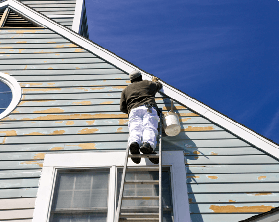 Ladder Safety img 1 (1) A man on a ladder paints a home