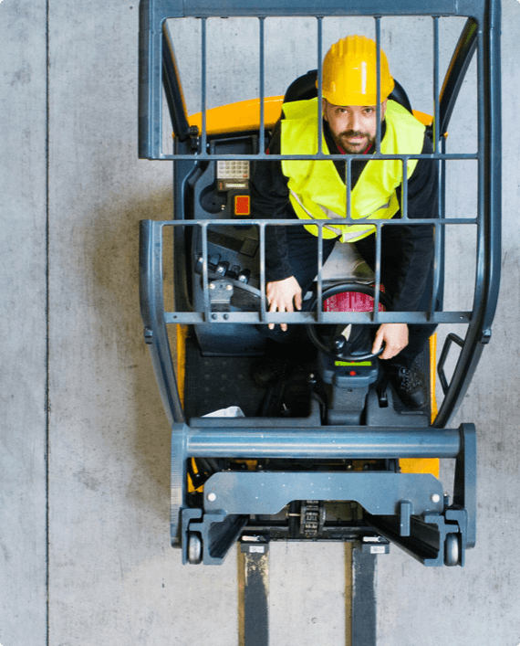 Lift Truck -french img 2 (1) A man looks up as he operates a forklift