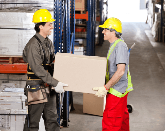 Two employees carry a heavy box together