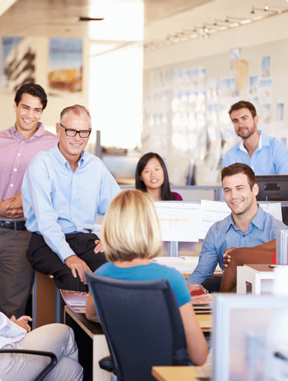 A group of employees receives training about office ergonomics