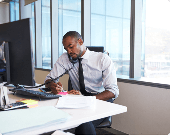 Provincial Safety Committee Training img 2 A man speaking on a phone takes notes