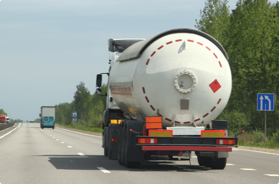A truck carrying dangerous materials drives on the highway