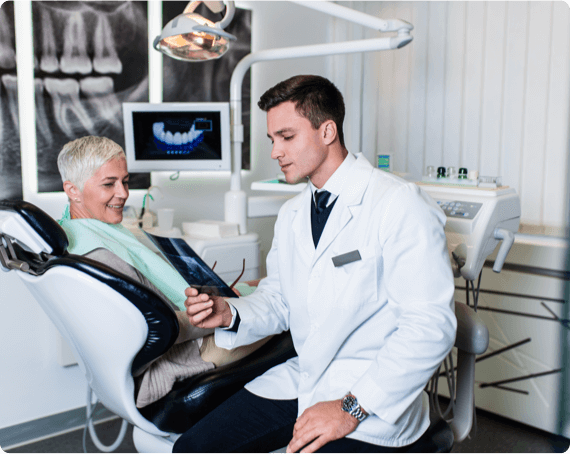 WHIMS health img 2 A dentist reviews x-rays of a patients mouth
