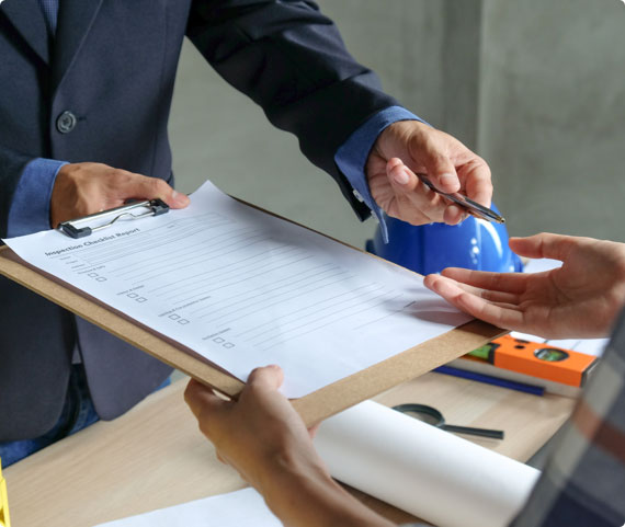 A workplace investigator hands a clipboard and pen to a manager