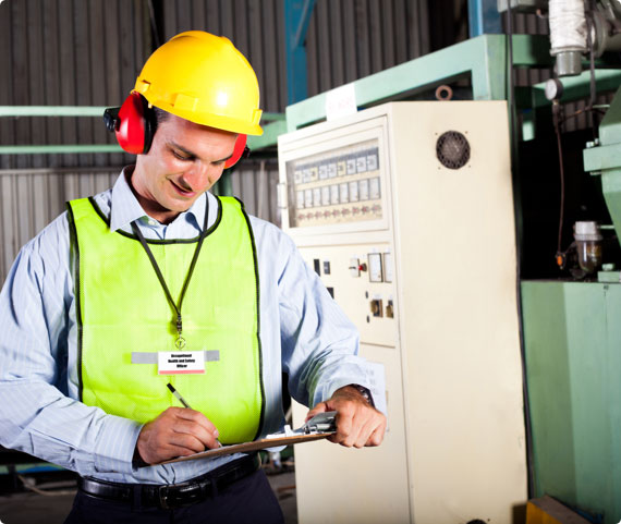 A safety inspector takes notes on a clipboard