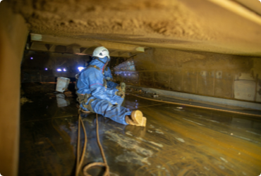 A trapped worker waits to be rescued from a confined space