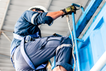 A worker is hoisted to the top of a platform