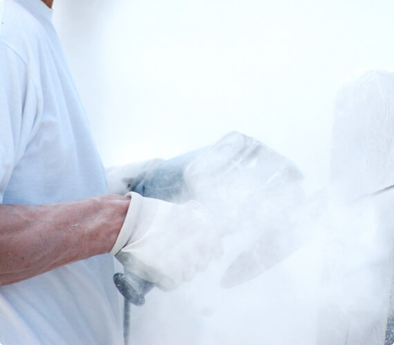 A man operates a circular saw as a cloud of ultrafine particles surrounds him