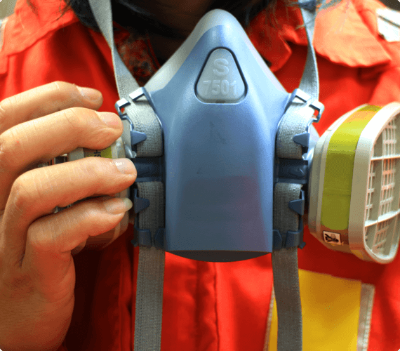 site inspection img 2 (1) A workplace inspector puts on a respirator