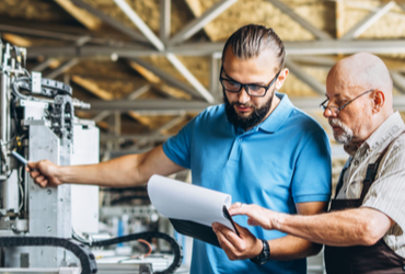 A health and safety representative discusses safety with an employee