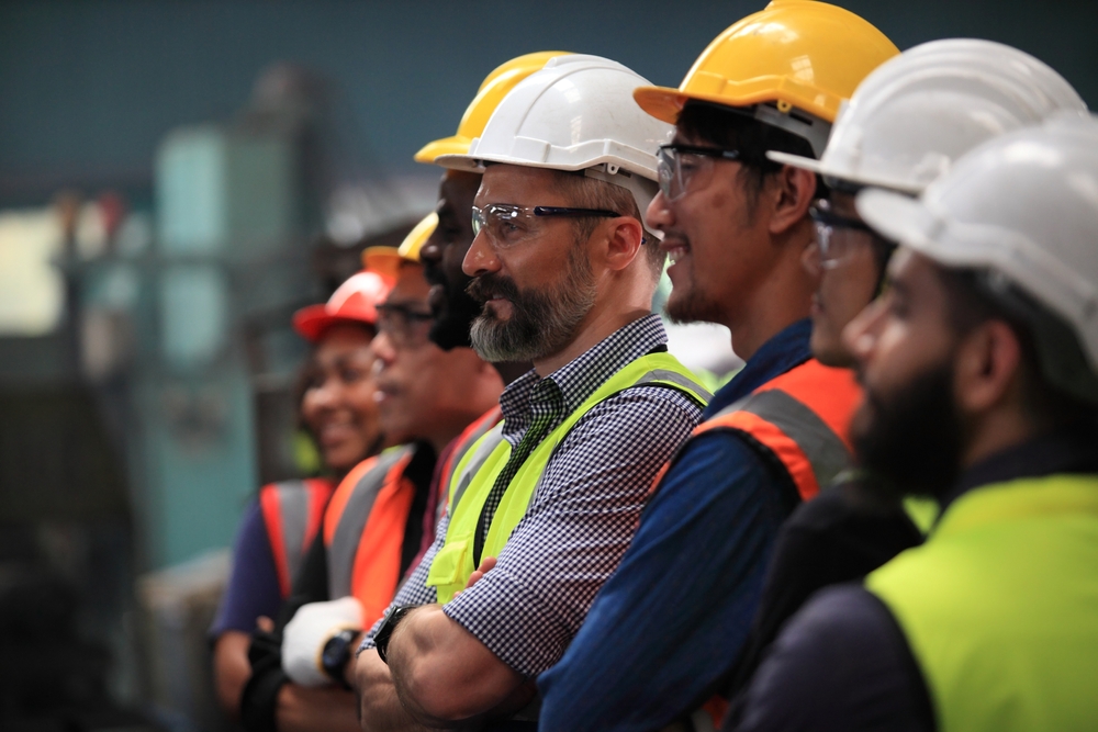 lineup of warehouse workers listening to a safety training seminar