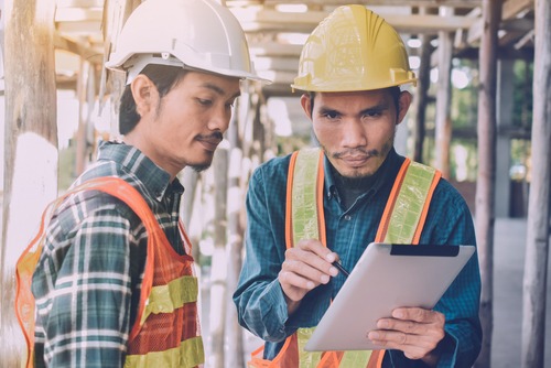worker looks over training with coworker