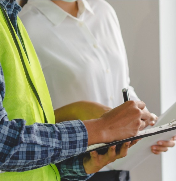 Auspice Safety Consultant Writing On A Clip Board During Workplace Assessment