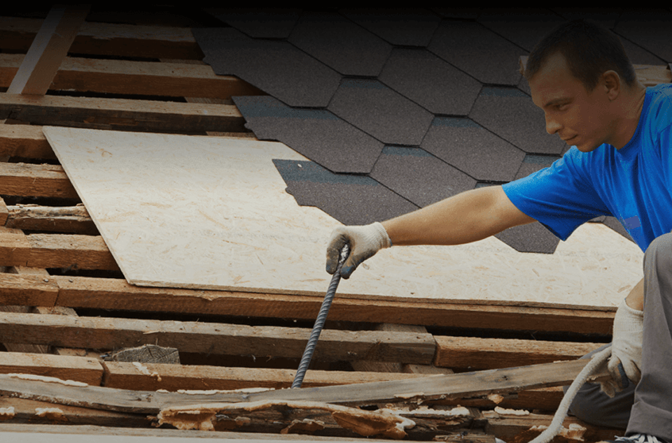 fall protection A man doing roofing wearing fall protection equipment